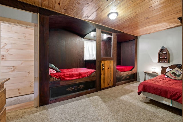 bedroom with wood walls, carpet flooring, and wood ceiling