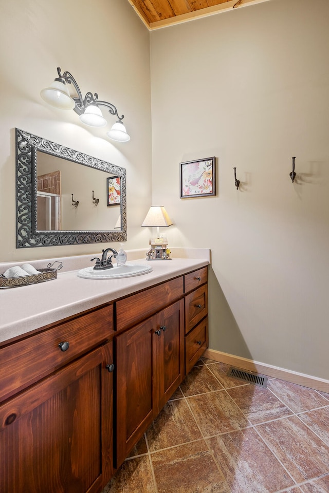 bathroom featuring visible vents, vanity, and baseboards