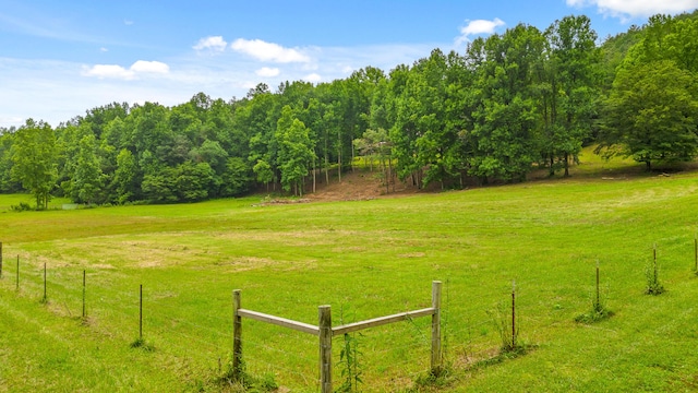 view of yard featuring fence and a rural view