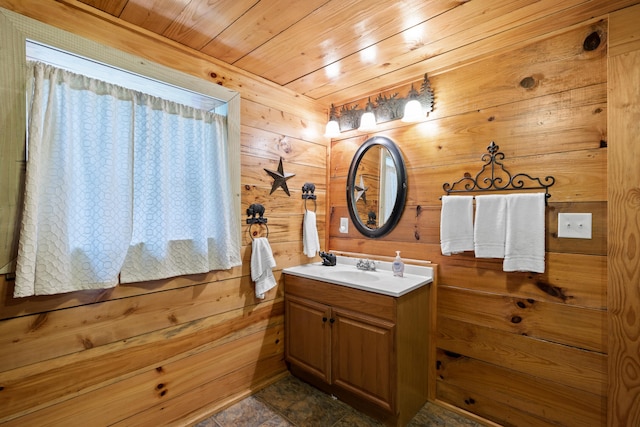 bathroom featuring wooden ceiling, wood walls, and vanity