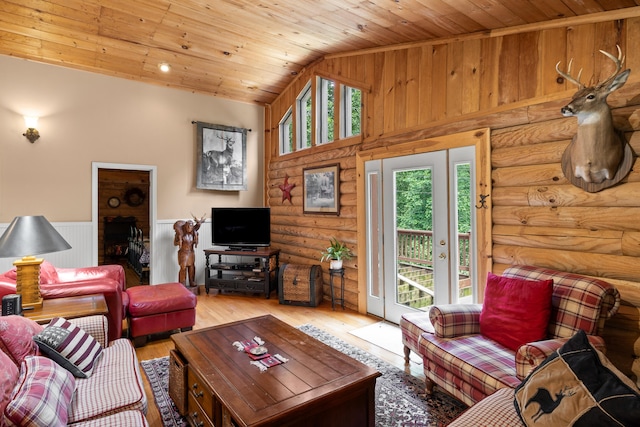 living area with a wainscoted wall, high vaulted ceiling, wood finished floors, and wood ceiling