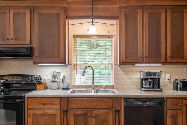 kitchen with decorative backsplash, brown cabinetry, under cabinet range hood, black appliances, and a sink