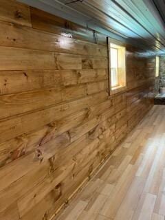 below grade area with wood walls and wood finished floors