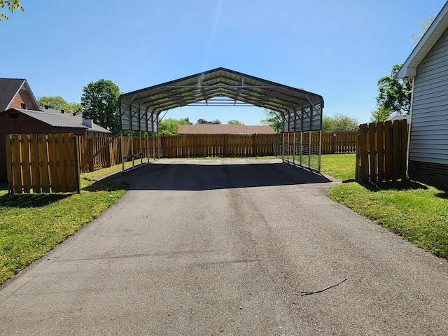 exterior space with a carport and a yard