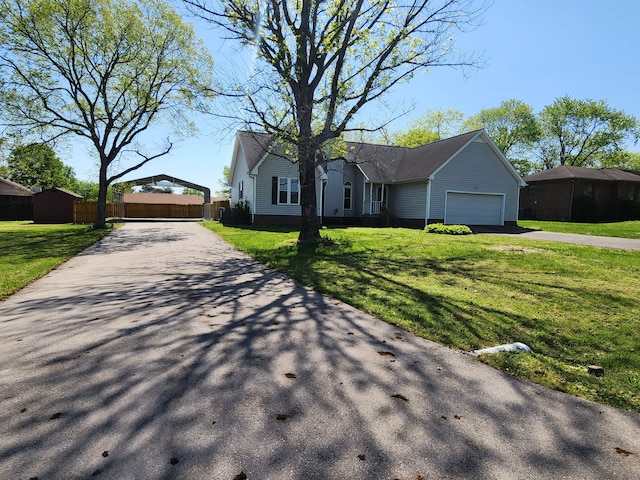 single story home featuring a front lawn and a garage