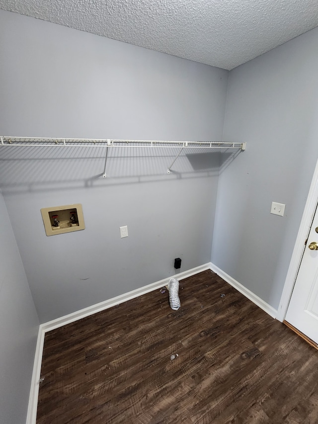 laundry room featuring washer hookup, a textured ceiling, and wood-type flooring