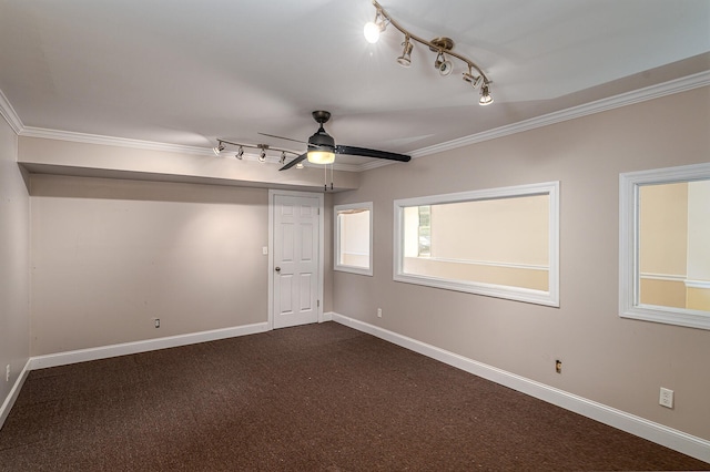 unfurnished room with ceiling fan, crown molding, track lighting, and dark colored carpet