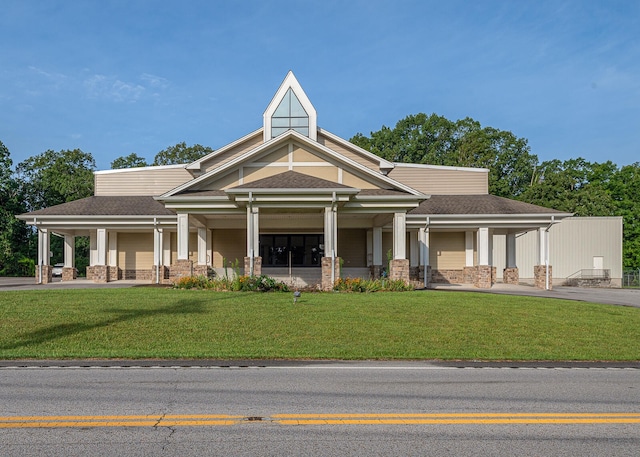 view of front of house with a front yard and covered porch