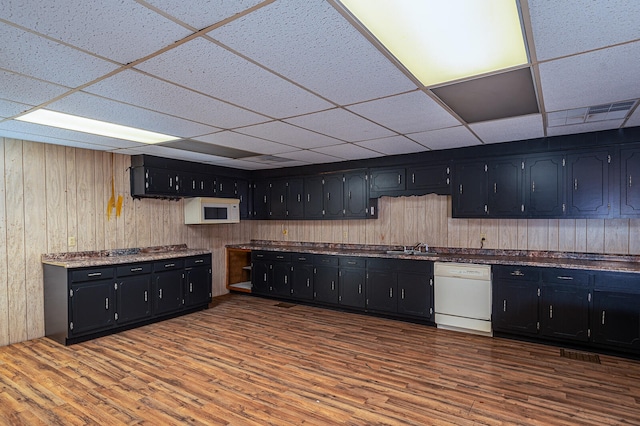 kitchen with dark hardwood / wood-style flooring, white appliances, a drop ceiling, and sink