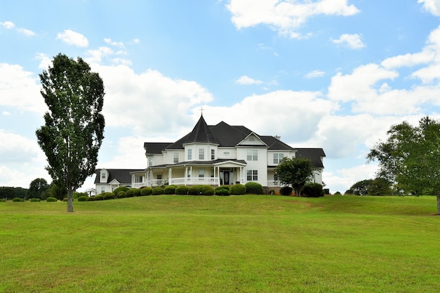 victorian home with covered porch and a front yard