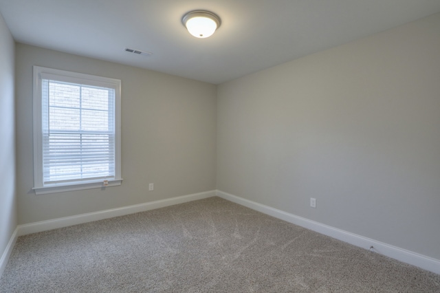 empty room featuring light colored carpet