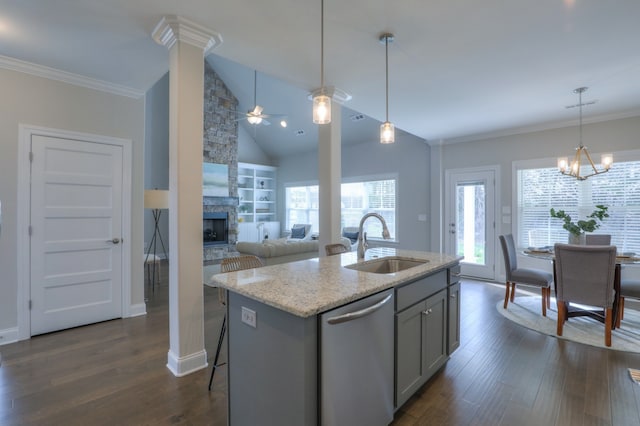 kitchen with sink, dark hardwood / wood-style flooring, stainless steel dishwasher, a fireplace, and ceiling fan with notable chandelier