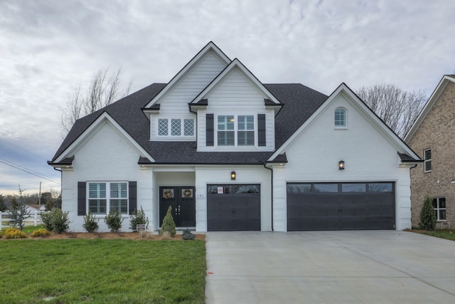 view of front of property featuring a front lawn and a garage