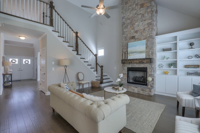 living room featuring dark hardwood / wood-style floors, a fireplace, high vaulted ceiling, and a healthy amount of sunlight