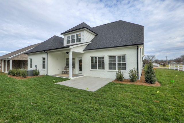 rear view of property with central AC, a patio area, and a yard