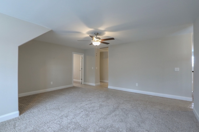 carpeted empty room featuring ceiling fan