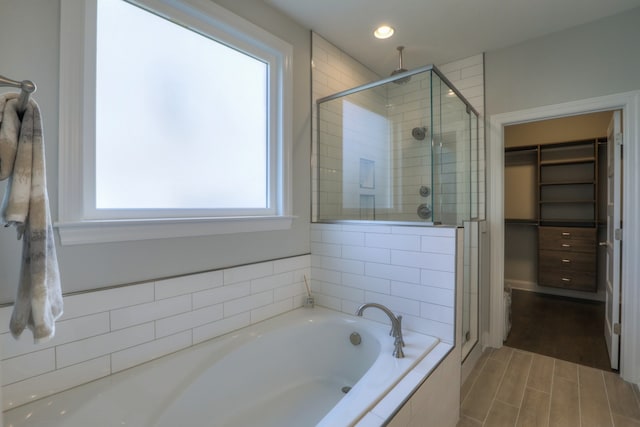 bathroom with hardwood / wood-style floors and plus walk in shower