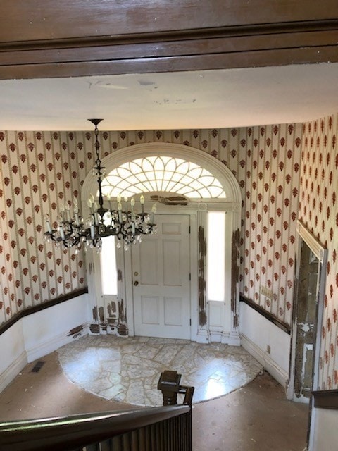 foyer entrance featuring a notable chandelier