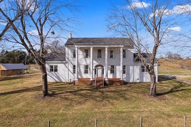 neoclassical home with a front lawn