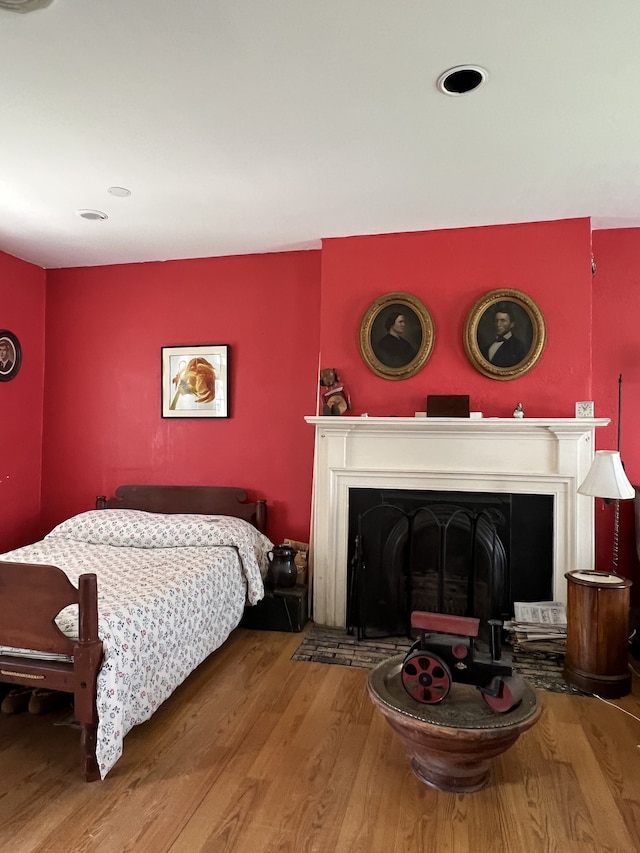 bedroom with hardwood / wood-style floors