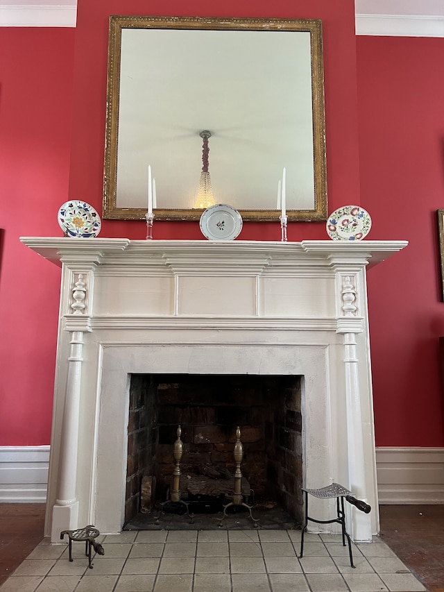 room details featuring a high end fireplace, ornamental molding, and hardwood / wood-style flooring