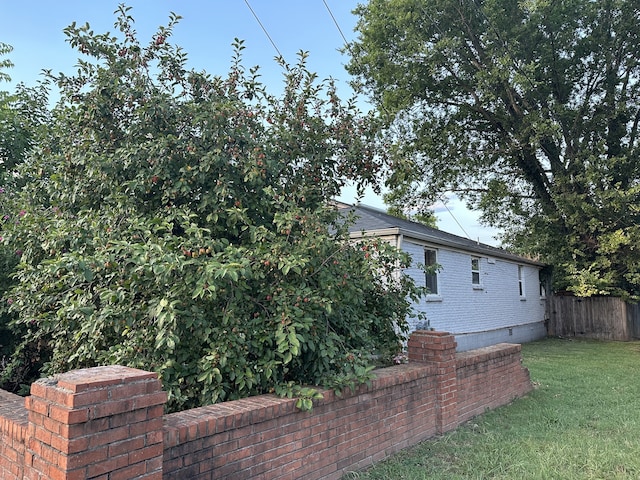 view of side of home featuring a yard