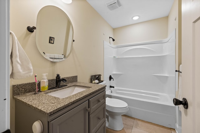 full bathroom featuring toilet, washtub / shower combination, tile floors, and vanity