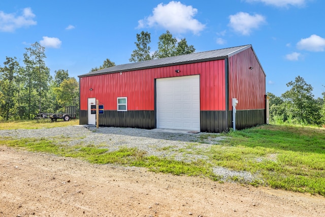 view of shed / structure with a yard and a garage