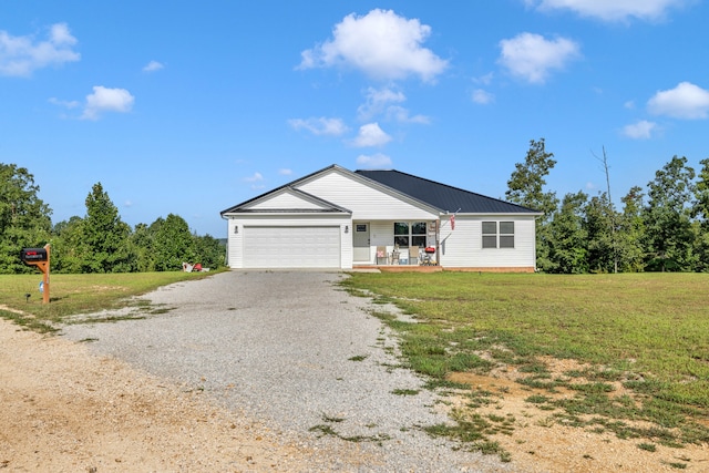 ranch-style house featuring covered porch, a front lawn, and a garage