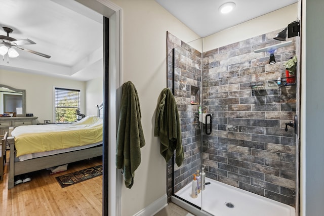 bathroom with ceiling fan, walk in shower, vanity, and wood-type flooring