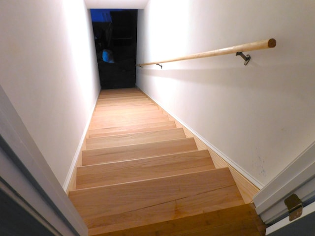 staircase with light hardwood / wood-style floors