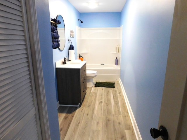 full bathroom featuring toilet, vanity, shower / bath combination, and wood-type flooring