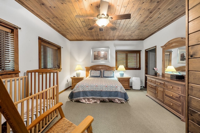 bedroom featuring light carpet, ceiling fan, wooden ceiling, and ornamental molding