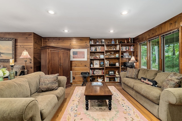 living room featuring light hardwood / wood-style floors and wooden walls