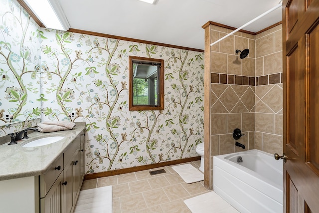 full bathroom featuring tiled shower / bath, tile flooring, toilet, crown molding, and large vanity