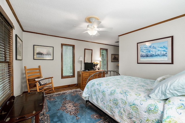 bedroom featuring ornamental molding, ceiling fan, and a textured ceiling