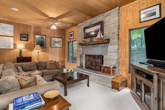 living room featuring wooden walls, ceiling fan, wood ceiling, and light colored carpet