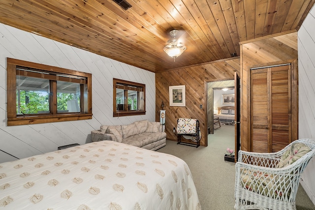 carpeted bedroom featuring wood ceiling, wooden walls, and a closet