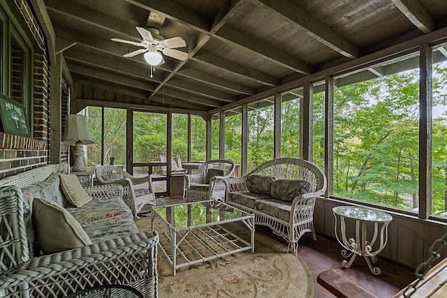 sunroom featuring a wealth of natural light, vaulted ceiling, ceiling fan, and wooden ceiling