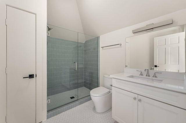 bathroom featuring tile floors, toilet, vanity, and a shower with shower door