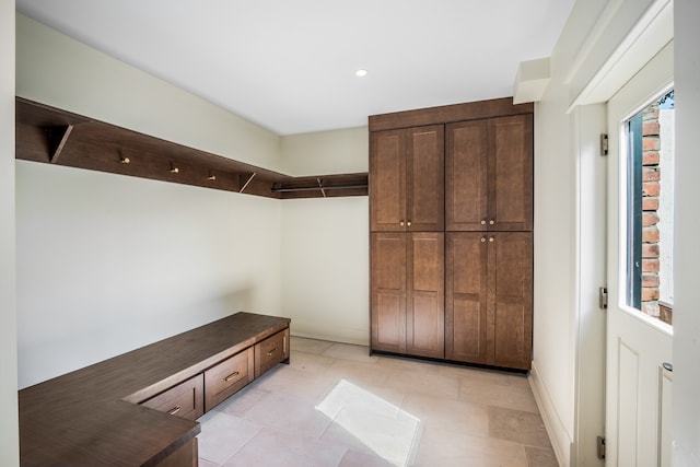 spacious closet featuring light tile floors