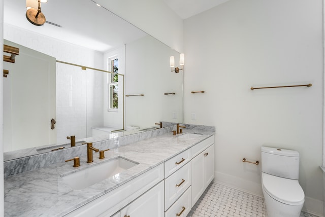 bathroom with tile floors, toilet, and double vanity