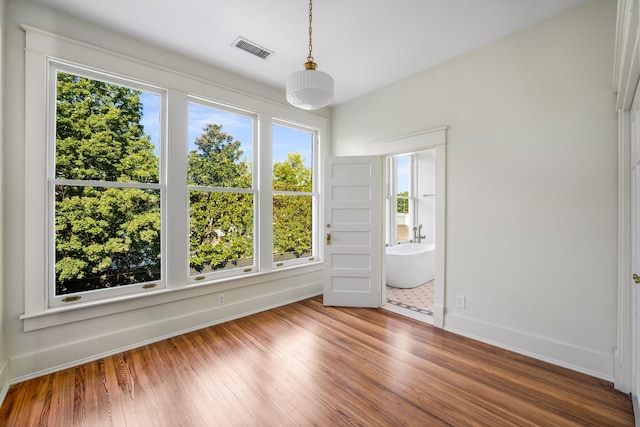 spare room featuring wood-type flooring