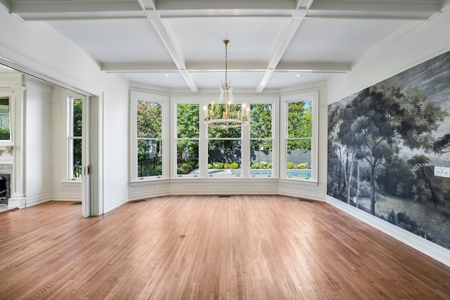 interior space featuring beamed ceiling, coffered ceiling, a chandelier, and light wood-type flooring