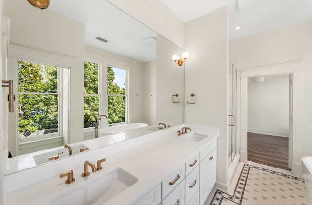 bathroom with tile floors, dual vanity, and independent shower and bath