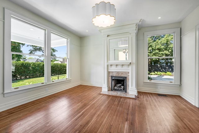 unfurnished living room with plenty of natural light and dark hardwood / wood-style floors