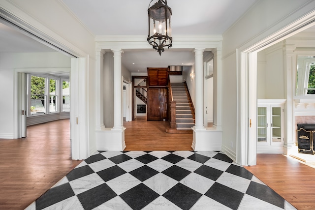 entryway with a notable chandelier, a healthy amount of sunlight, and light hardwood / wood-style flooring