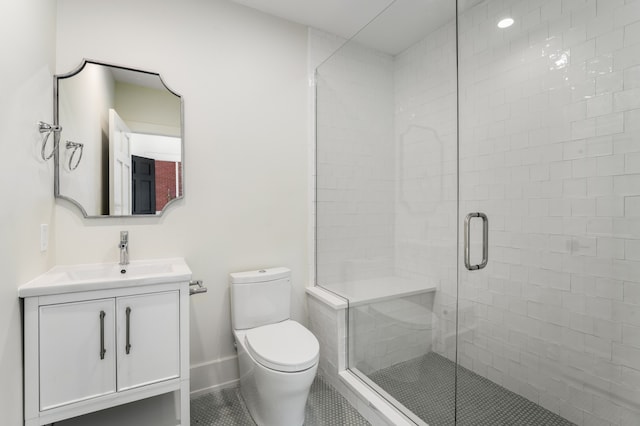 bathroom with vanity, tile flooring, a shower with door, and toilet