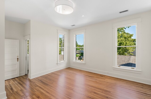 empty room featuring light hardwood / wood-style floors and a healthy amount of sunlight