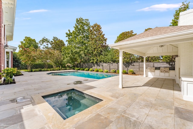 view of pool with a patio area, an in ground hot tub, and area for grilling